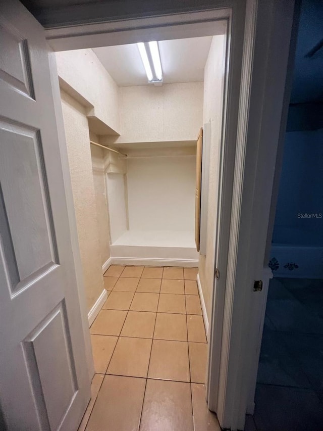 spacious closet with light tile patterned flooring