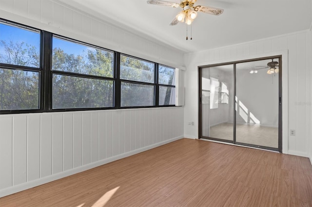 spare room with light wood-type flooring and ceiling fan