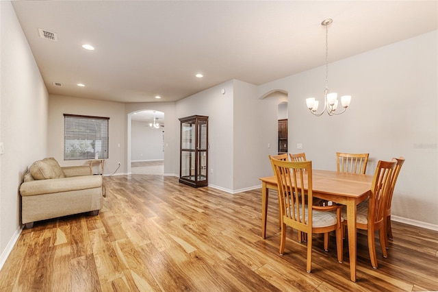 dining room featuring an inviting chandelier and light hardwood / wood-style flooring