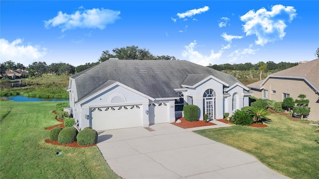 view of front of home featuring a garage and a front lawn