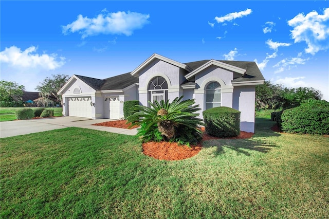 single story home with a front yard and a garage