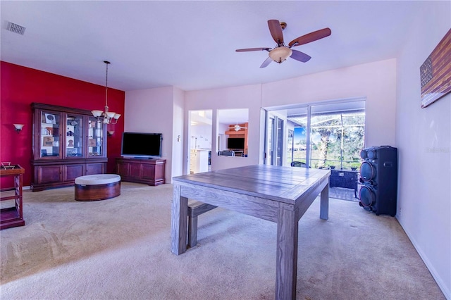 interior space with ceiling fan with notable chandelier and light carpet