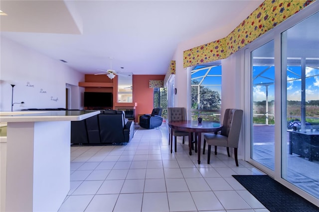 dining space with ceiling fan and light tile patterned floors