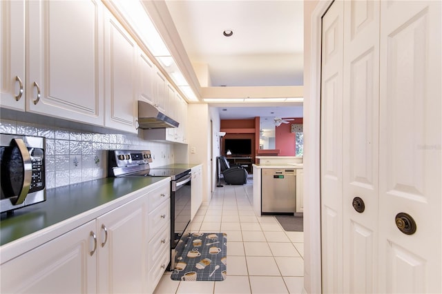 kitchen with ceiling fan, decorative backsplash, light tile patterned floors, white cabinetry, and stainless steel appliances