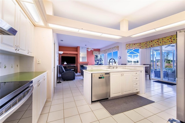 kitchen with appliances with stainless steel finishes, ceiling fan, sink, light tile patterned floors, and white cabinetry