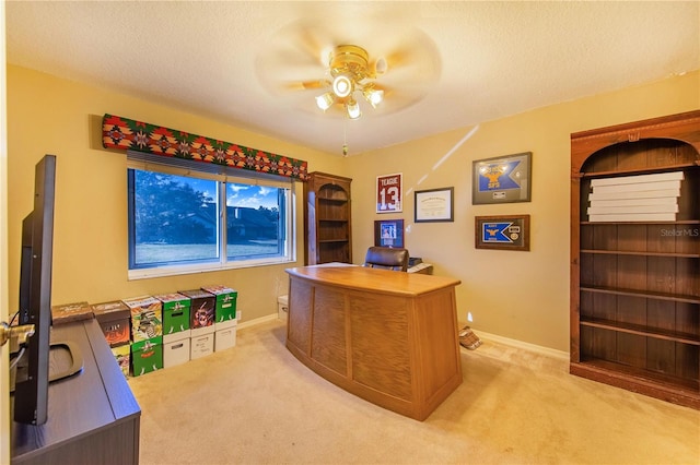 office with a textured ceiling, light colored carpet, and ceiling fan