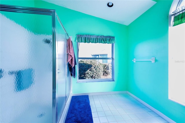 bathroom featuring tile patterned floors, a shower with door, and lofted ceiling