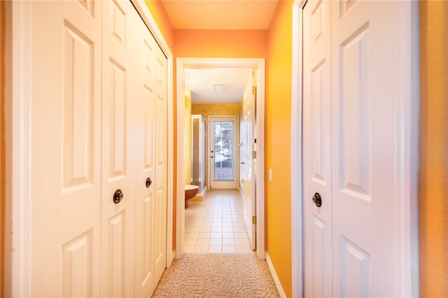 corridor with light tile patterned floors