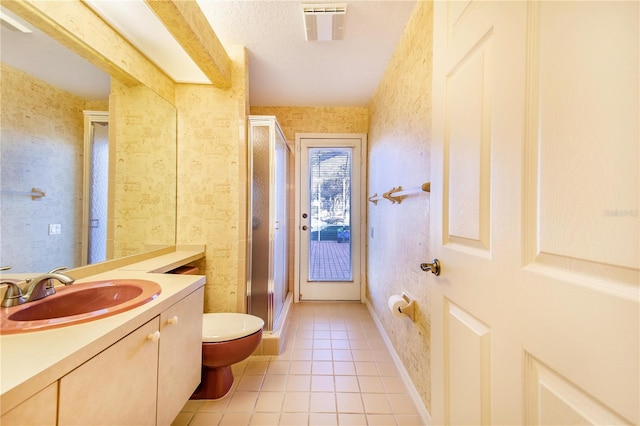 bathroom featuring walk in shower, a textured ceiling, vanity, tile patterned flooring, and toilet