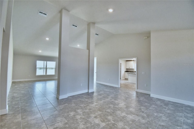 unfurnished room with lofted ceiling