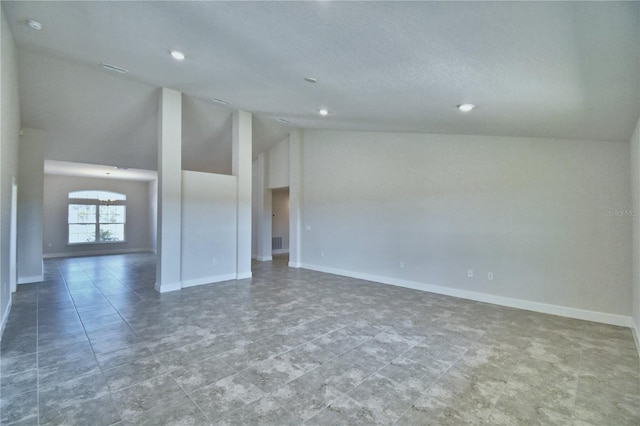 unfurnished room featuring vaulted ceiling