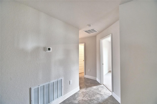 hall with light tile patterned floors