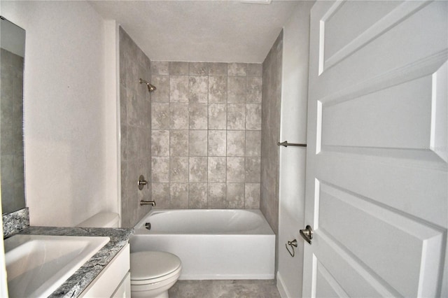 full bathroom featuring vanity, tiled shower / bath combo, and toilet