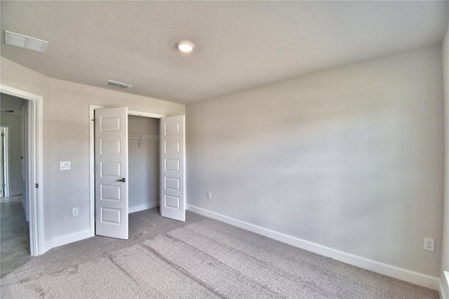 unfurnished bedroom with carpet and a closet