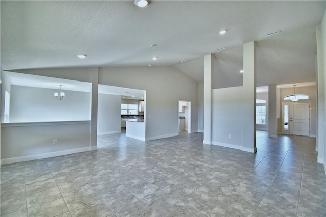 empty room with a wealth of natural light and high vaulted ceiling