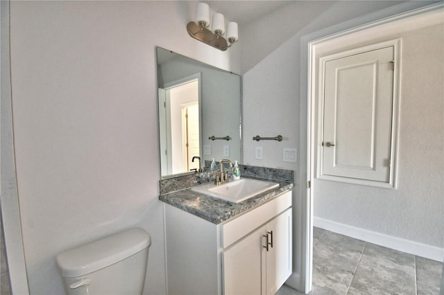 bathroom with vanity, toilet, and tile patterned flooring