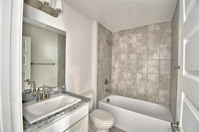 full bathroom featuring tiled shower / bath combo, vanity, and toilet