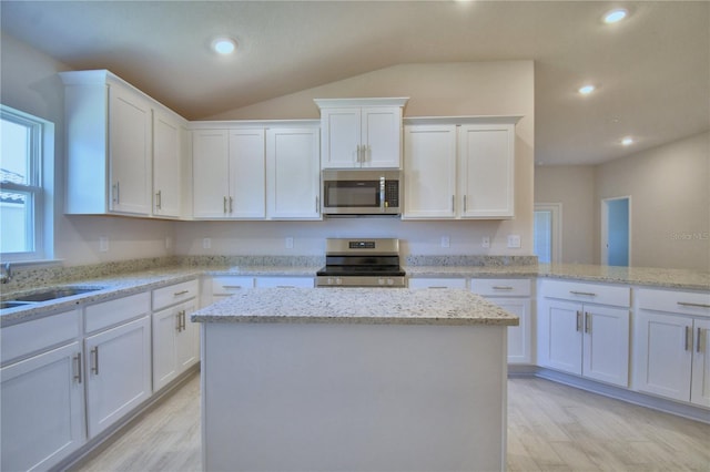kitchen featuring a sink, appliances with stainless steel finishes, a center island, white cabinets, and recessed lighting