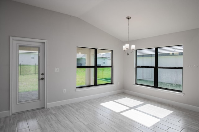 unfurnished dining area featuring light hardwood / wood-style floors, an inviting chandelier, and plenty of natural light