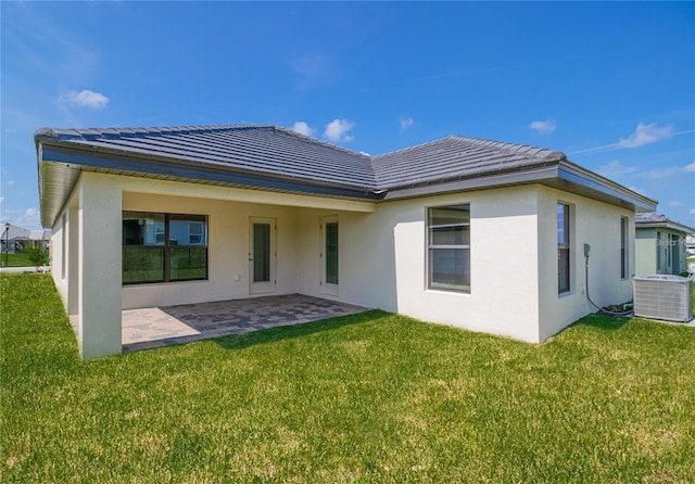 back of house with a yard, a patio, and central air condition unit