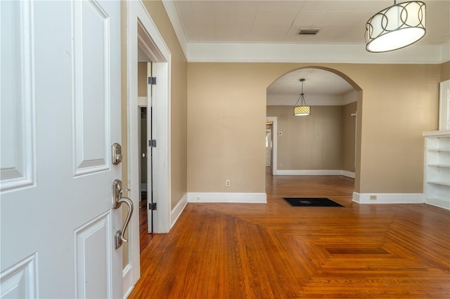 entryway featuring ornamental molding and parquet floors