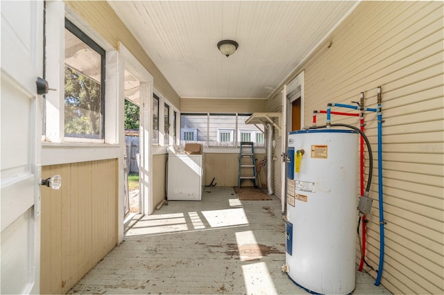 sunroom / solarium featuring washer / clothes dryer and water heater