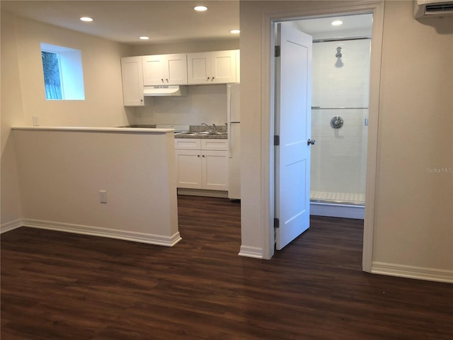 kitchen with white cabinets, dark hardwood / wood-style floors, and sink