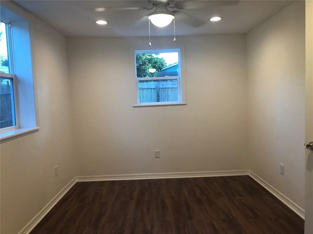 spare room with ceiling fan and dark wood-type flooring