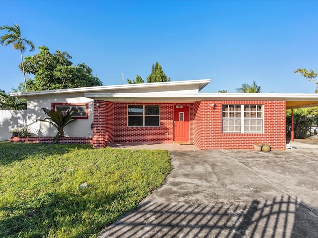 ranch-style house featuring a front yard and a carport