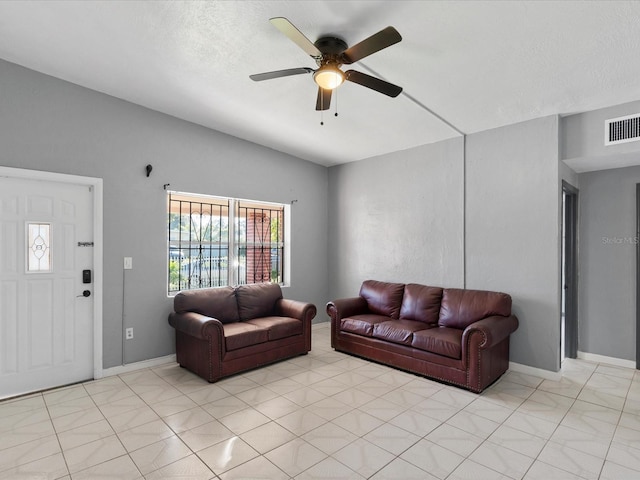 living room with a textured ceiling, vaulted ceiling, and ceiling fan