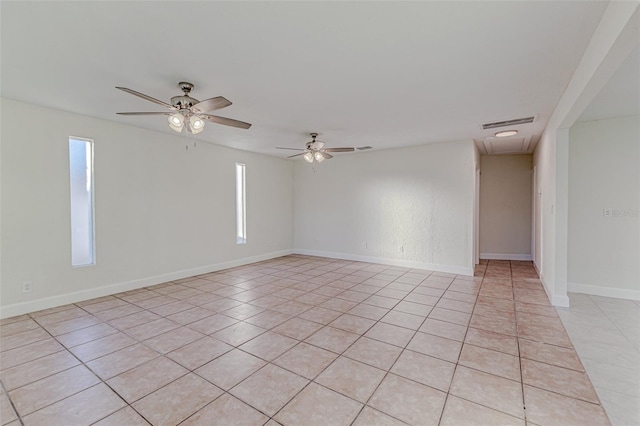 tiled empty room with ceiling fan