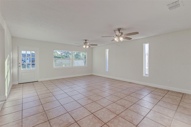 tiled empty room with ceiling fan