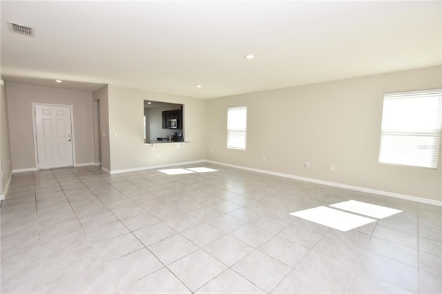 unfurnished room with light tile patterned floors