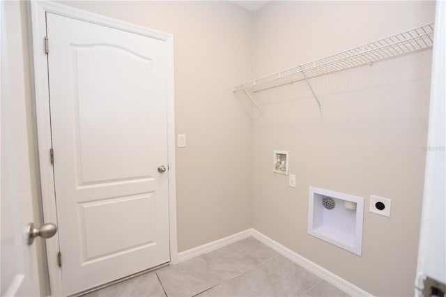 laundry room with hookup for a washing machine, light tile patterned floors, and electric dryer hookup