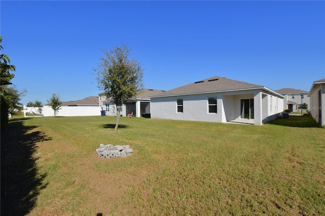 back of property featuring a lawn