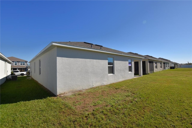 view of side of home with a lawn