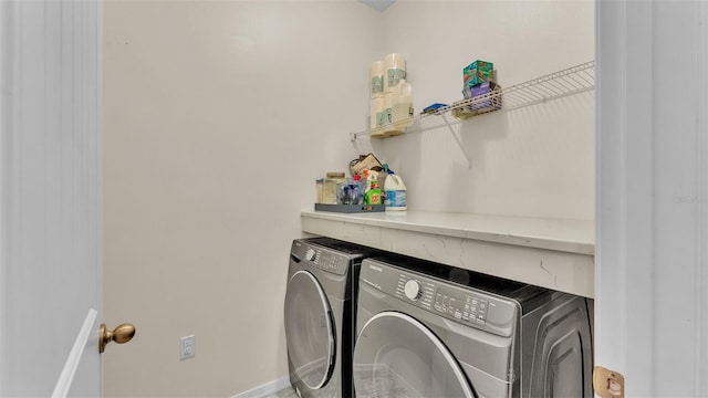 clothes washing area with washer and clothes dryer