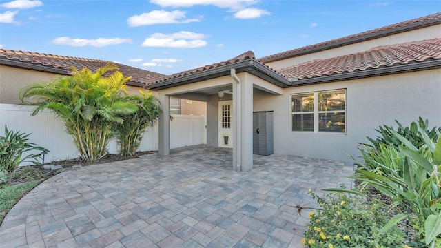 exterior space featuring ceiling fan