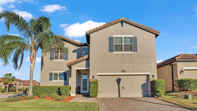 mediterranean / spanish-style home with a garage and a front yard