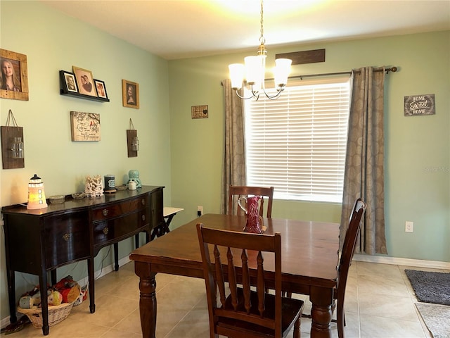 dining space featuring light tile patterned floors and an inviting chandelier