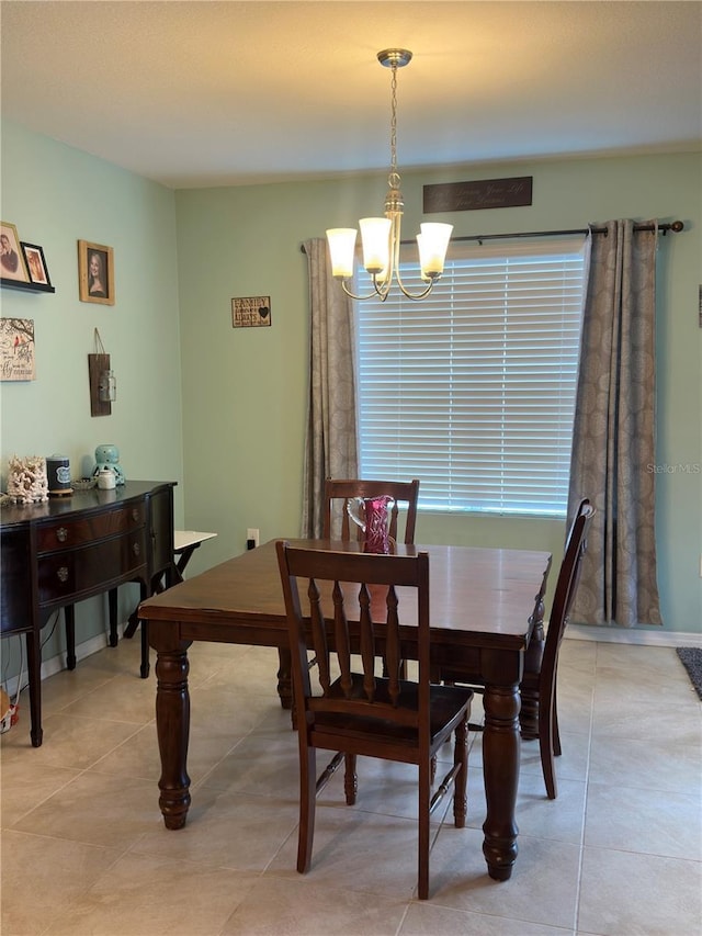 tiled dining area with a chandelier