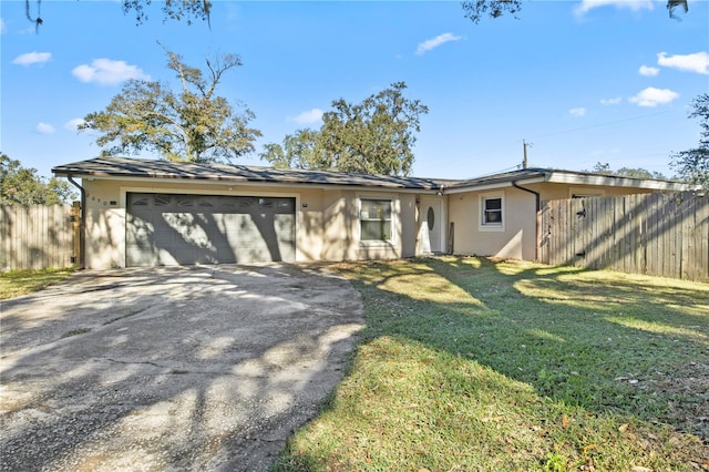 ranch-style home with a garage and a front lawn