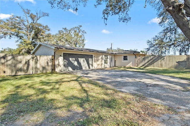 ranch-style house with a front yard and a garage