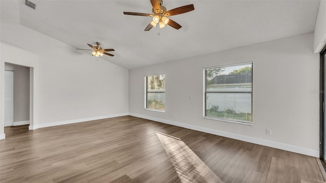 empty room featuring hardwood / wood-style floors, ceiling fan, and lofted ceiling