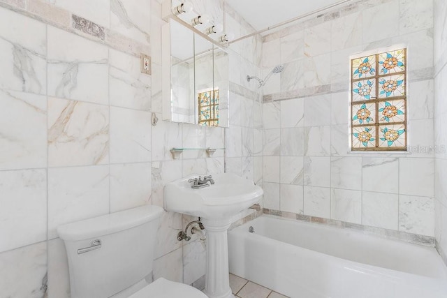 bathroom with shower / bathtub combination, toilet, and tile walls