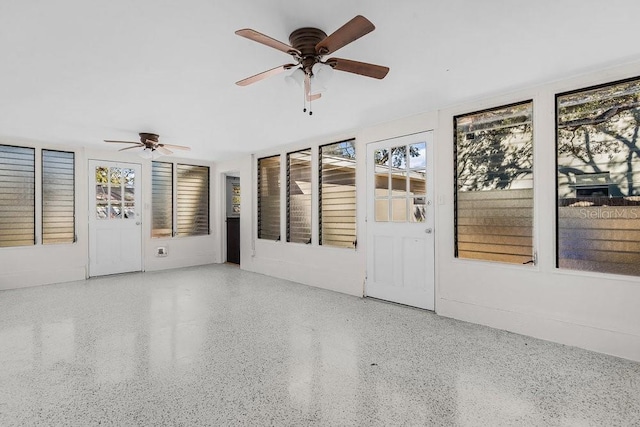 unfurnished sunroom with plenty of natural light and ceiling fan