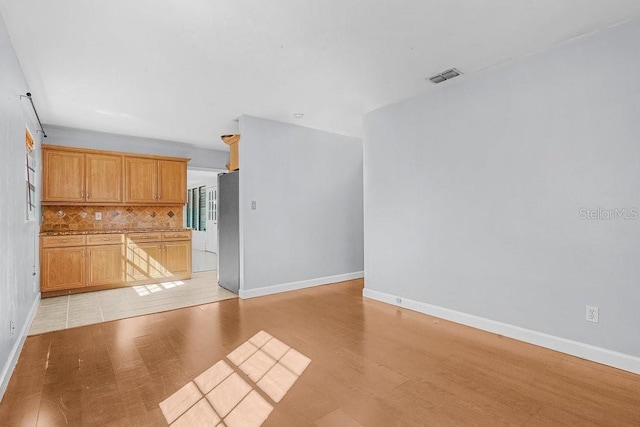 unfurnished living room with light hardwood / wood-style flooring