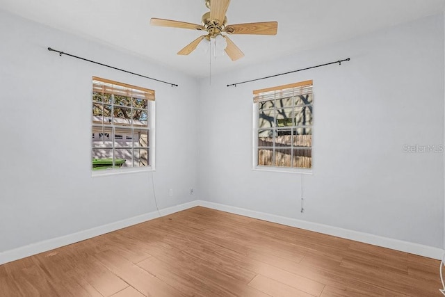 empty room with ceiling fan and hardwood / wood-style floors