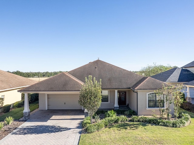 ranch-style house featuring a garage and a front yard