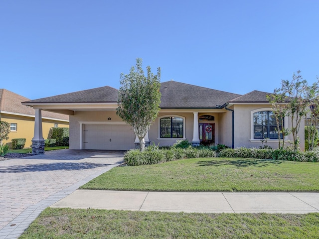 view of front of property featuring a front yard and a garage